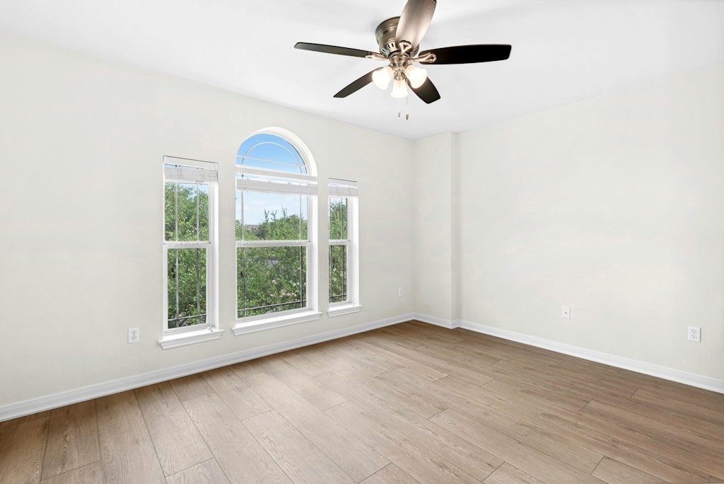 903 Fork Ridge Path Round Rock, TX 78665 - Photo 17 of 35 an empty room with wooden floor fan and windows