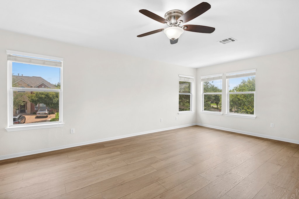 903 Fork Ridge Path Round Rock, TX 78665 - Photo 22 of 35 a view of an empty room with wooden floor and a window