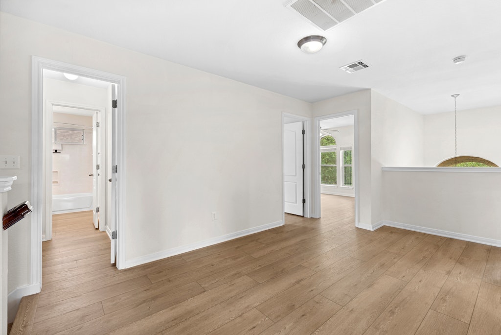 903 Fork Ridge Path Round Rock, TX 78665 - Photo 23 of 35 an empty room with wooden floor and a window