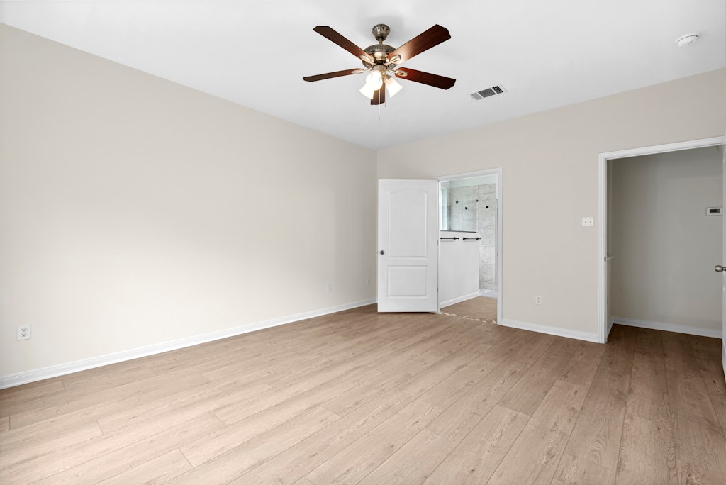 903 Fork Ridge Path Round Rock, TX 78665 - Photo 29 of 35 an empty room with wooden floor and a ceiling fan