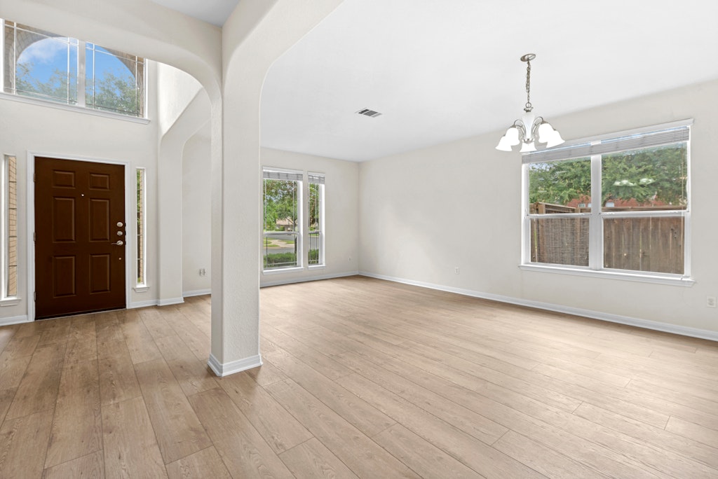 903 Fork Ridge Path Round Rock, TX 78665 - Photo 4 of 35 a view of livingroom with window wooden floor and front door