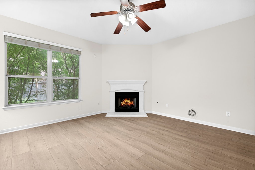 903 Fork Ridge Path Round Rock, TX 78665 - Photo 8 of 35 a view of an empty room with wooden floor and a window