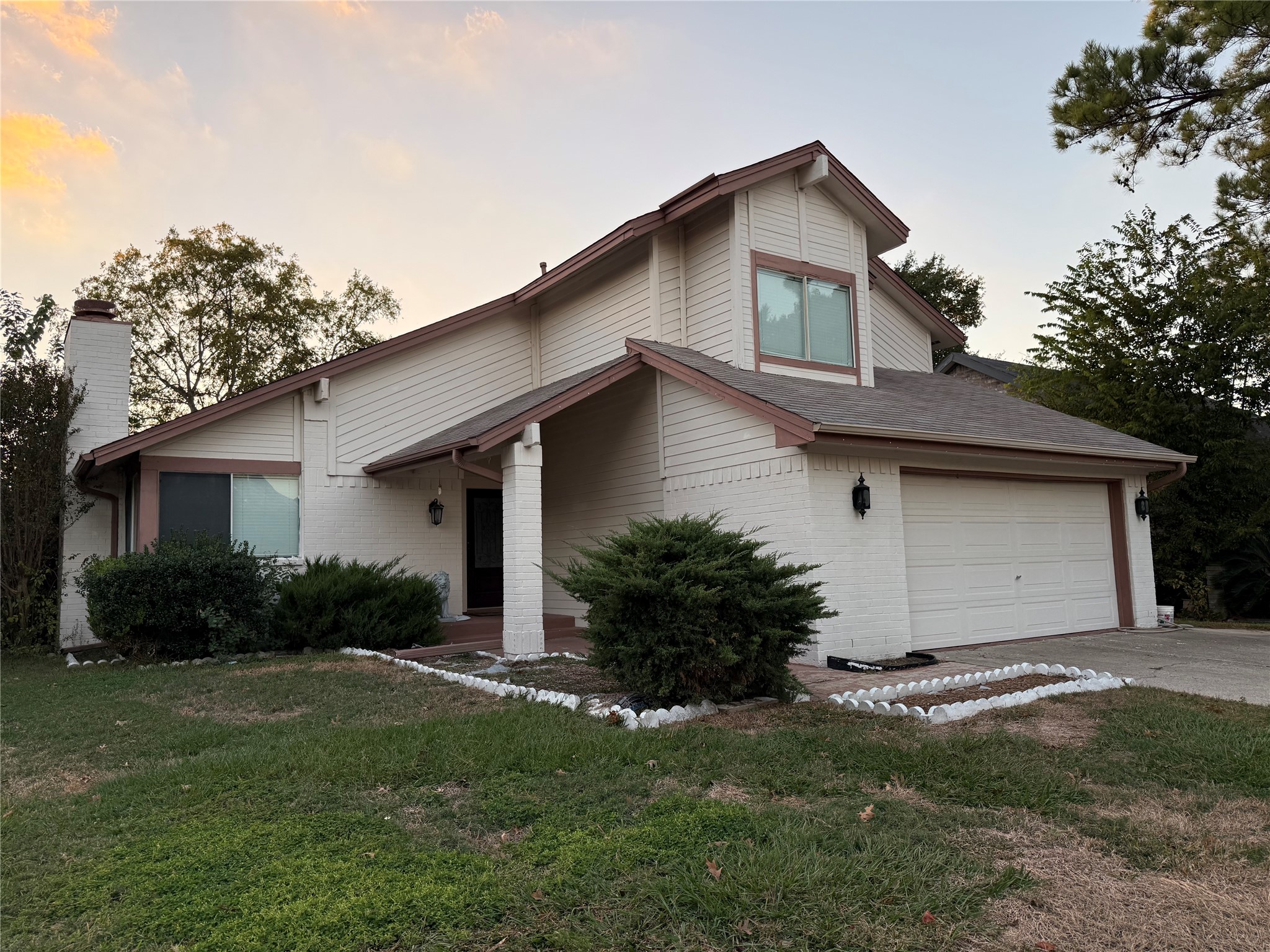 a front view of house with yard and green space