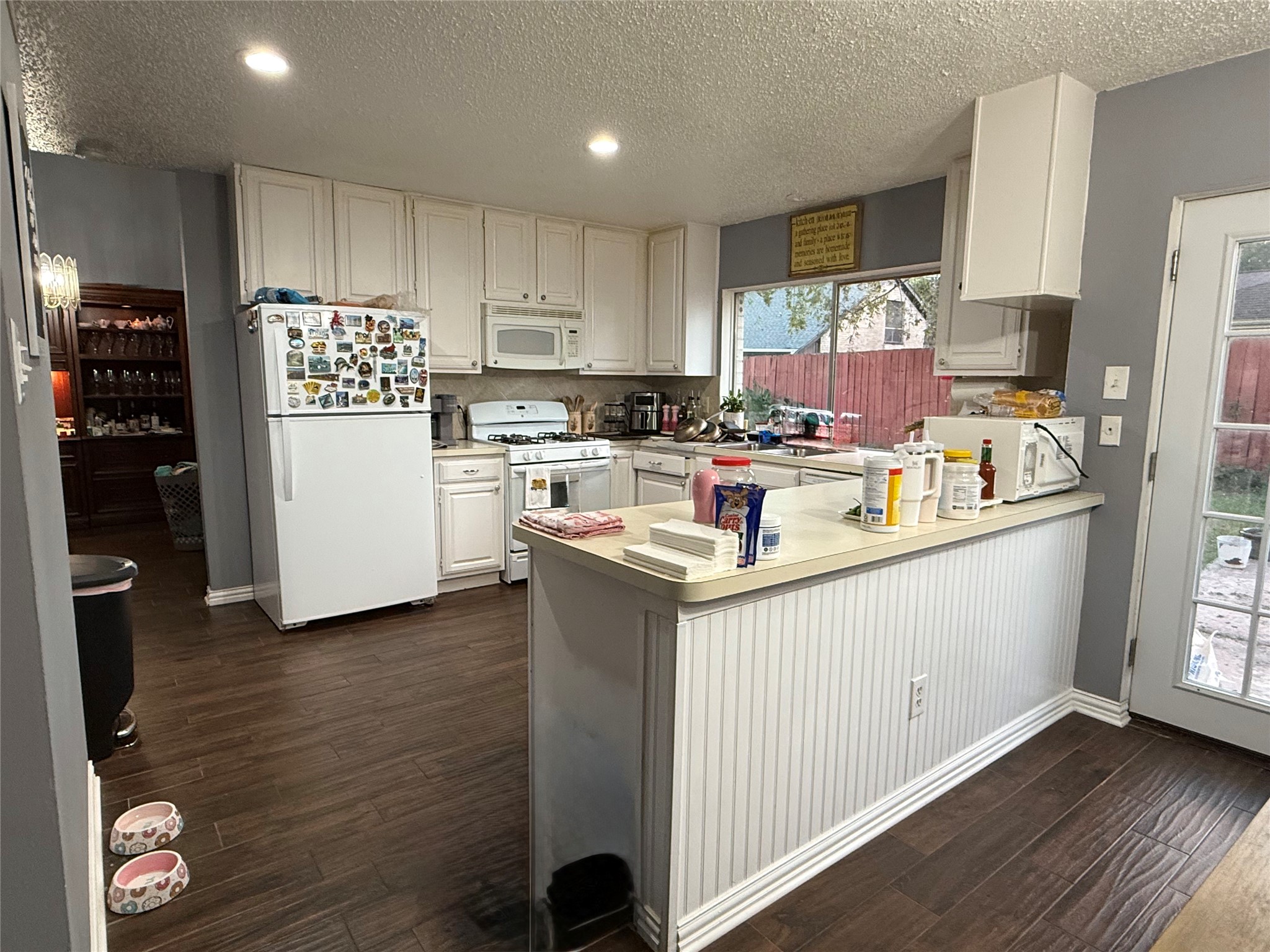 4211 Bridledon Lane Houston, TX 77014 - Photo 8 of 17 a kitchen with kitchen island granite countertop a sink cabinets and stainless steel appliances