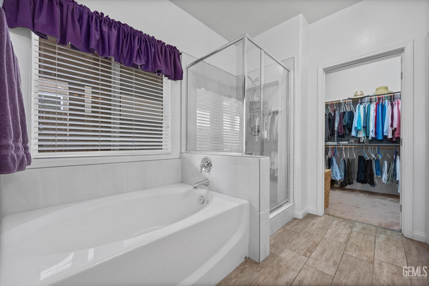 Undisclosed Address Bakersfield, CA 93313 - Photo 13 of 24 a bathroom with a bathtub and a window