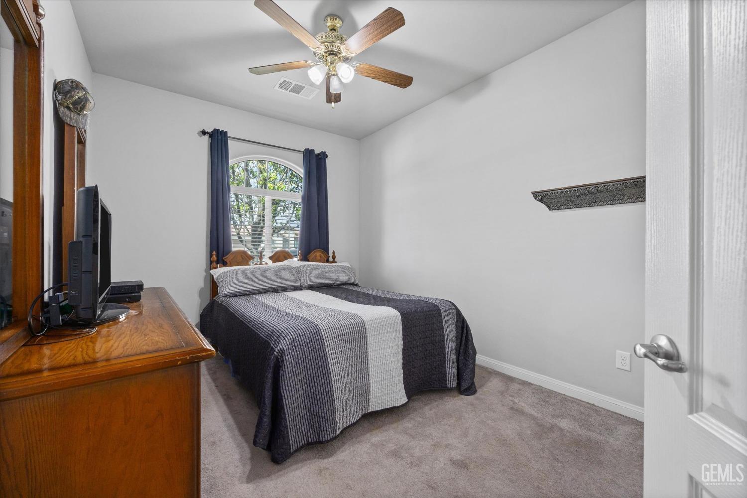 Undisclosed Address Bakersfield, CA 93313 - Photo 14 of 24 a bedroom with a bed and a flat screen tv