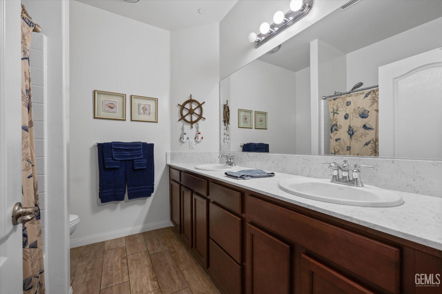 Undisclosed Address Bakersfield, CA 93313 - Photo 15 of 24 a bathroom with a sink a vanity and a mirror
