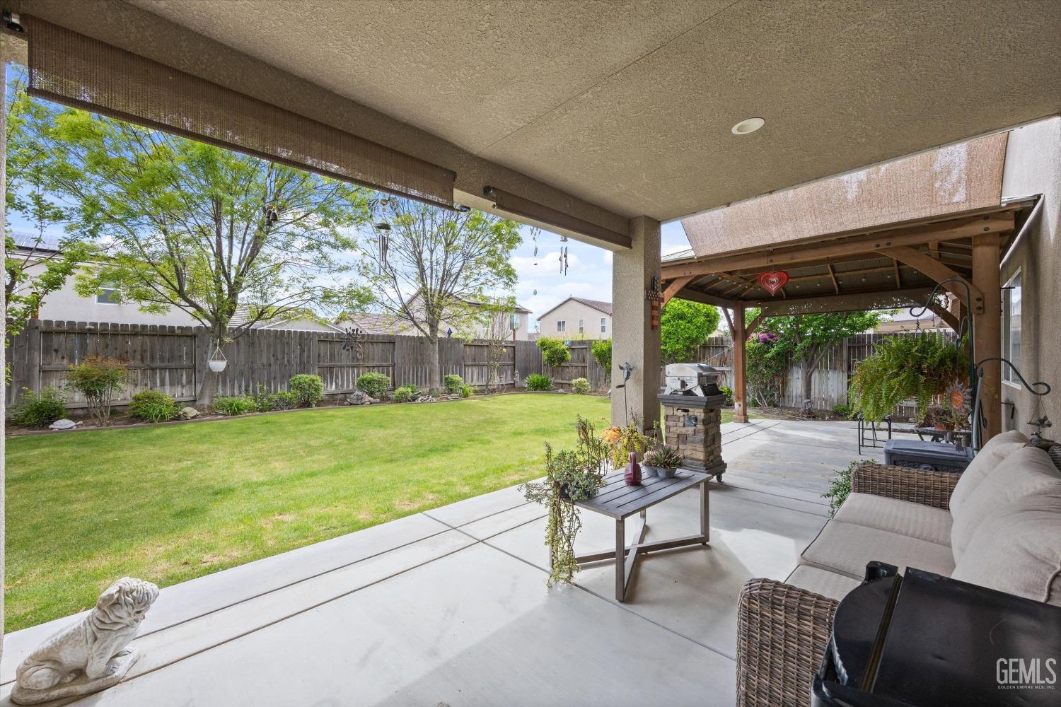 Undisclosed Address Bakersfield, CA 93313 - Photo 17 of 24 a view of a patio with couches chairs and a big yard
