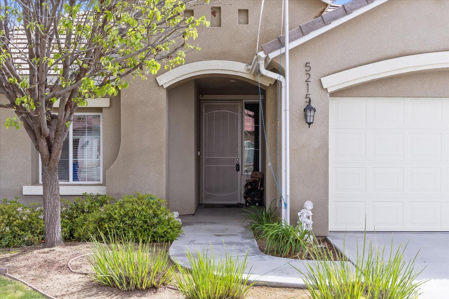 Undisclosed Address Bakersfield, CA 93313 - Photo 2 of 24 a front view of a house with garden