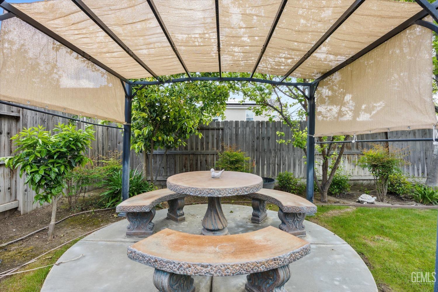 Undisclosed Address Bakersfield, CA 93313 - Photo 21 of 24 a view of a table and chairs in back yard of a house