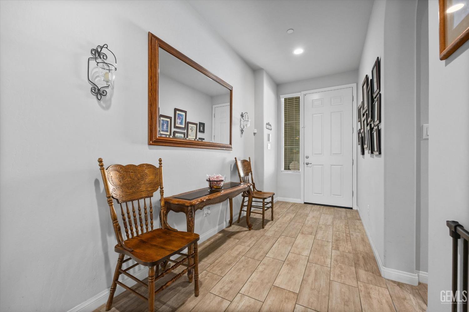 Undisclosed Address Bakersfield, CA 93313 - Photo 3 of 24 a view of a hallway to a livingroom with furniture and wooden floor