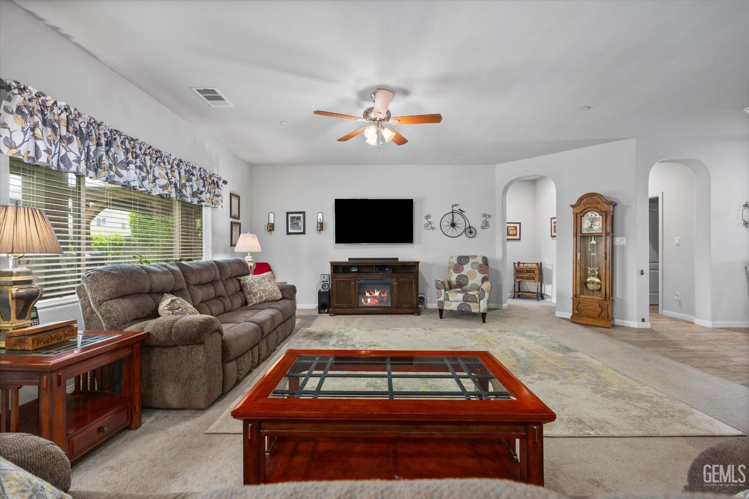 Undisclosed Address Bakersfield, CA 93313 - Photo 4 of 24 a living room with furniture a flat screen tv and a fireplace