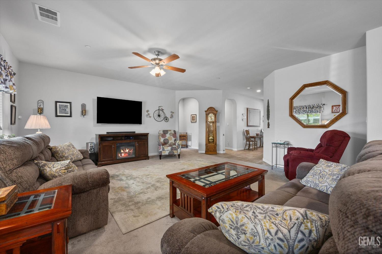 Undisclosed Address Bakersfield, CA 93313 - Photo 5 of 24 a living room with furniture a flat screen tv and a fireplace