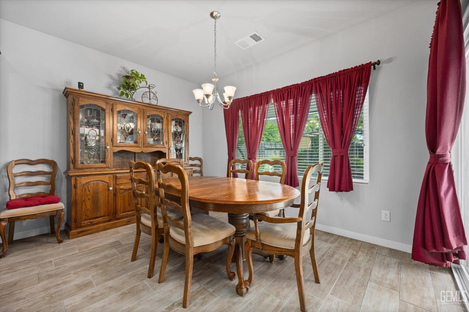 Undisclosed Address Bakersfield, CA 93313 - Photo 6 of 24 a view of a dining room with furniture window and wooden floor