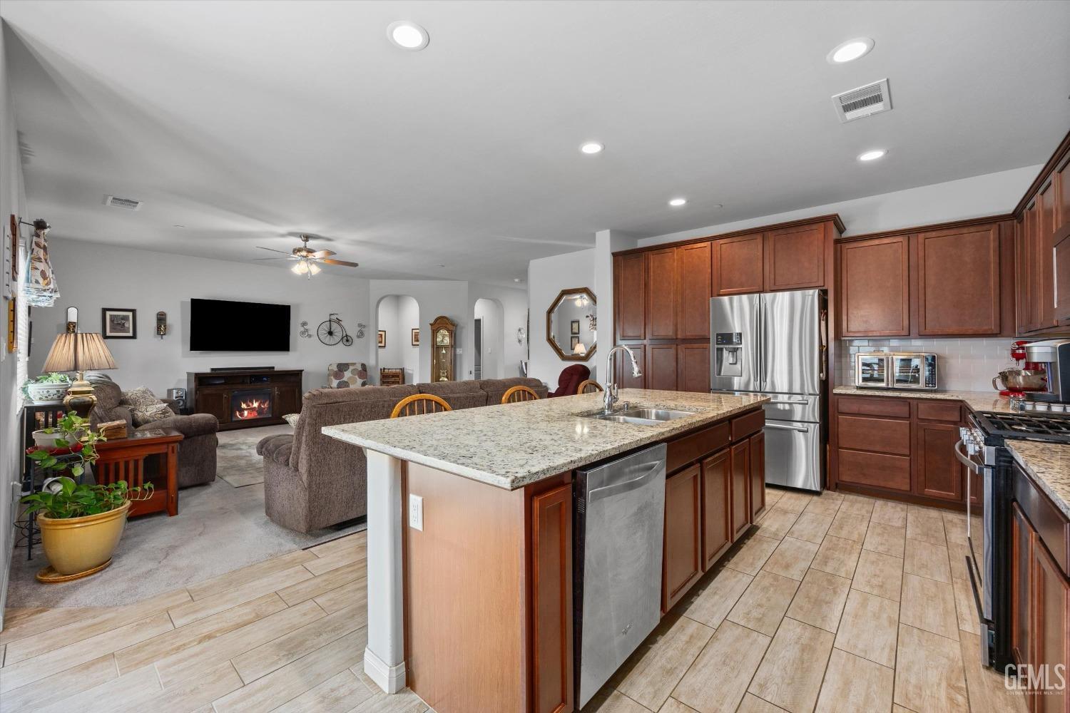 Undisclosed Address Bakersfield, CA 93313 - Photo 10 of 24 a kitchen with a stove and a wooden floor