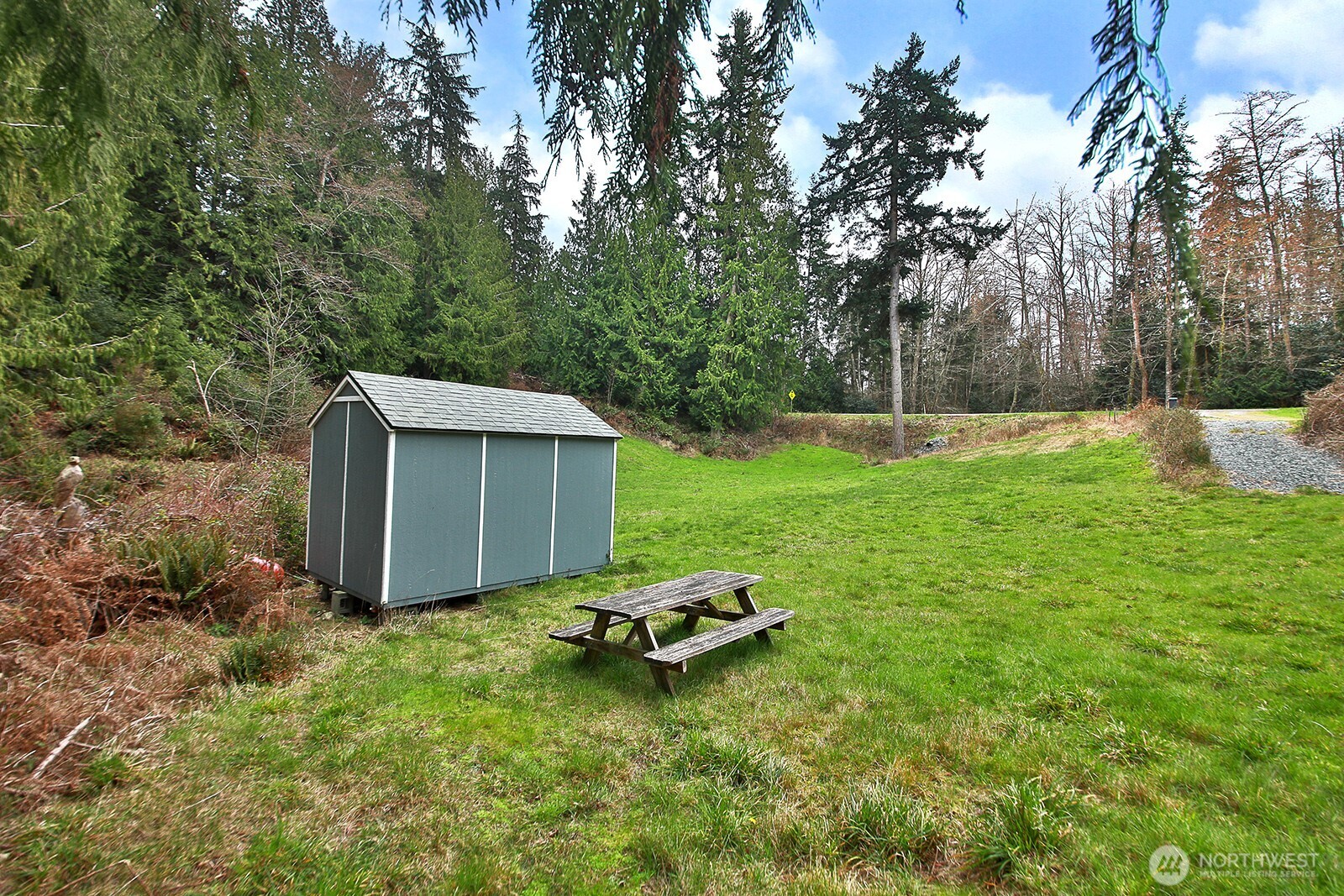 4985 Wilkinson Road Langley, WA 98260 - Photo 8 of 14 a view of a backyard with a garden and entertaining space