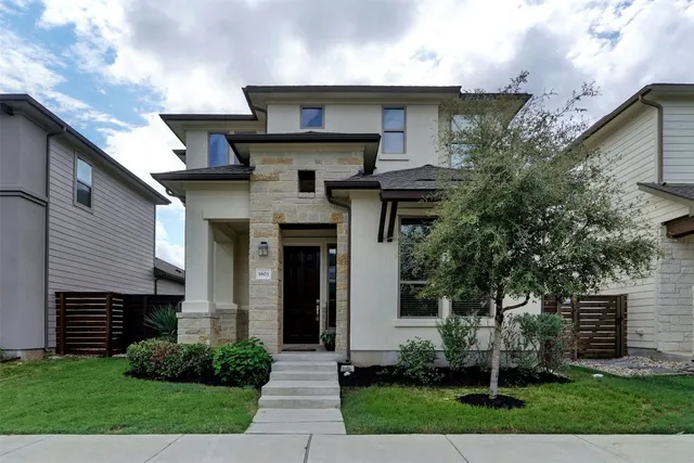 a front view of a house with a garden