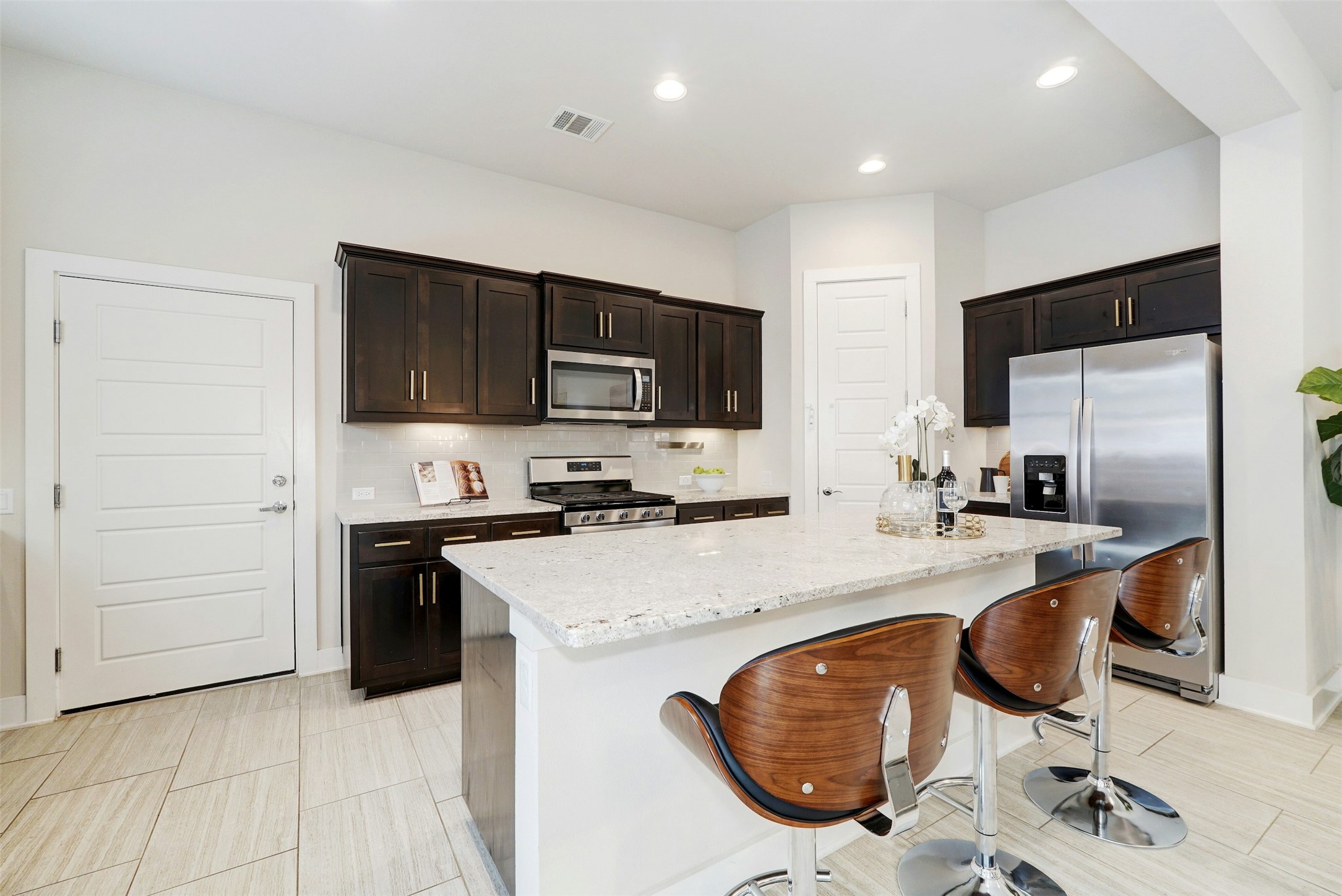 1603 Arcilla Street Austin, TX 78741 - Photo 11 of 36 a kitchen with stainless steel appliances granite countertop a sink stove and refrigerator