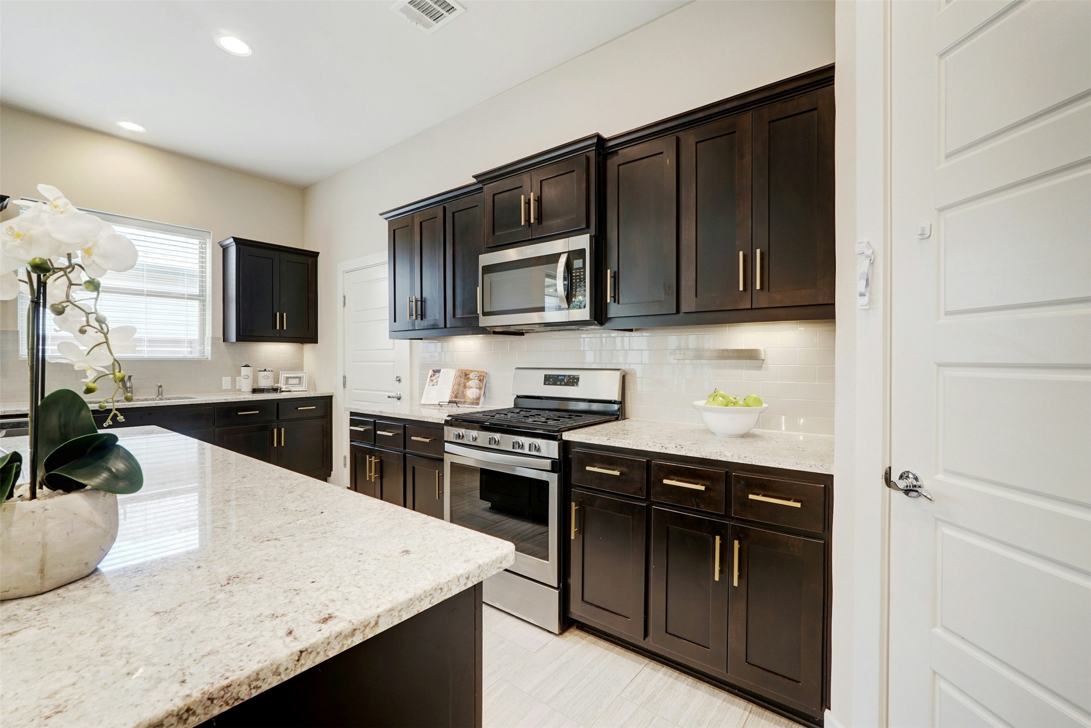 1603 Arcilla Street Austin, TX 78741 - Photo 12 of 36 a kitchen with granite countertop stainless steel appliances and wooden cabinets