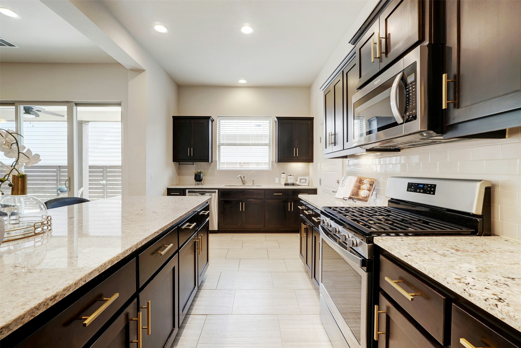 1603 Arcilla Street Austin, TX 78741 - Photo 13 of 36 a kitchen with stainless steel appliances granite countertop a stove a sink and a microwave