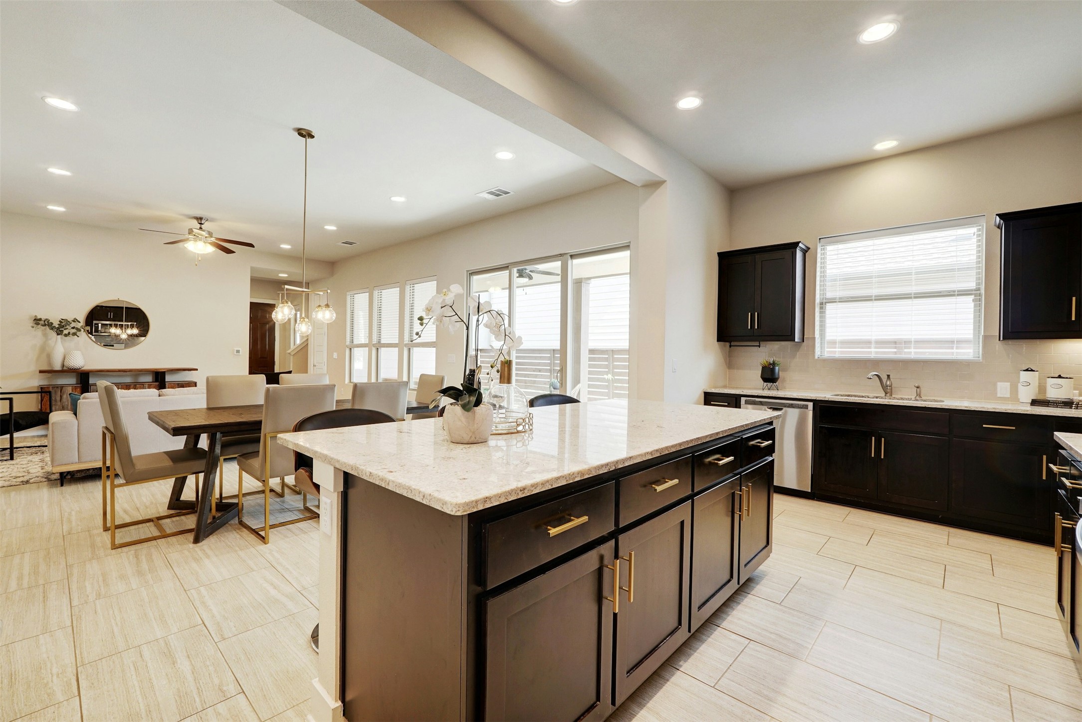 1603 Arcilla Street Austin, TX 78741 - Photo 14 of 36 a large kitchen with kitchen island a sink counter space appliances and a living room view