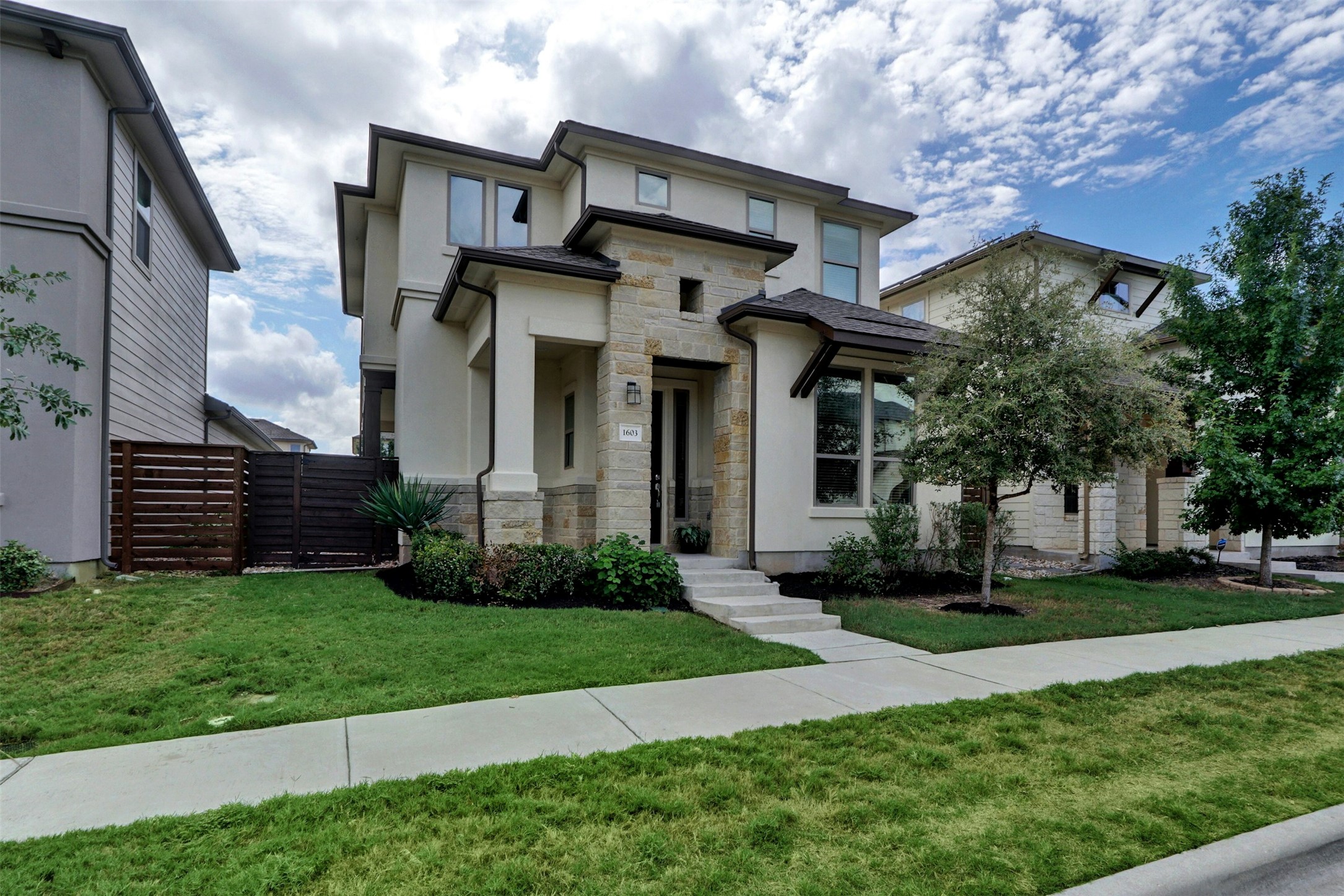 1603 Arcilla Street Austin, TX 78741 - Photo 2 of 36 a front view of a house with a garden