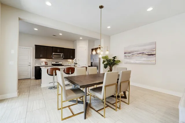 a view of a dining room with furniture and a flat screen tv