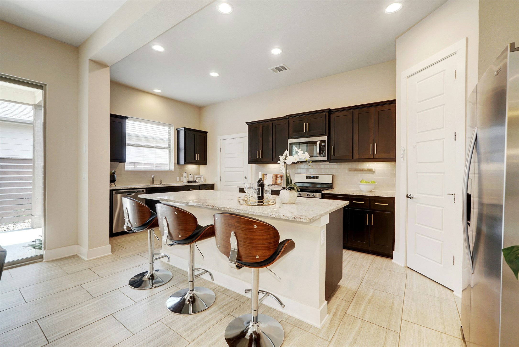 1603 Arcilla Street Austin, TX 78741 - Photo 10 of 36 a kitchen with granite countertop a refrigerator and a stove top oven
