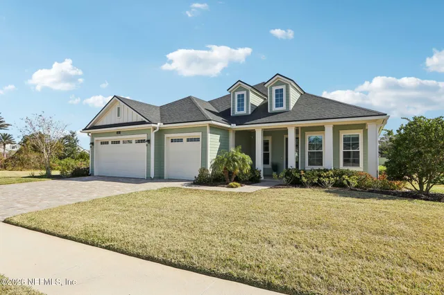 a view of a room with wooden floor and furniture