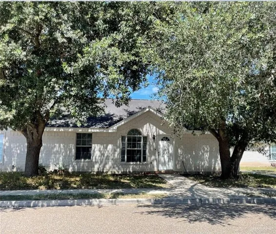 a front view of a house with trees