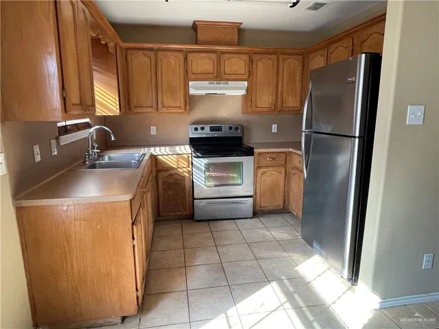 a kitchen with a refrigerator and a sink