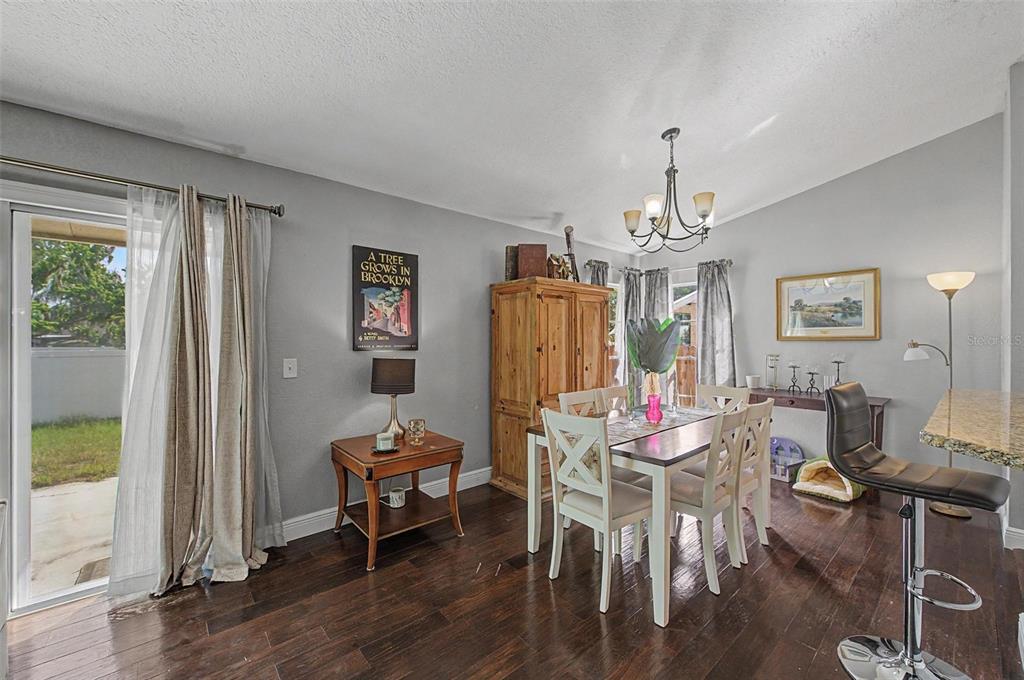 1632 Pintail Court Lutz, FL 33549 - Photo 10 of 34 a view of a dining room with furniture window and wooden floor