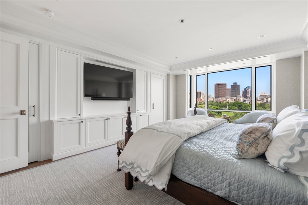 2 Commonwealth Avenue, Unit 11BCD Boston, MA 02116 - Photo 22 of 39 a bedroom with a bed and a flat screen tv