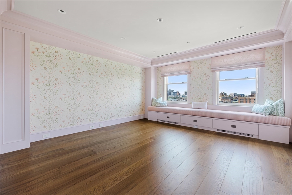 2 Commonwealth Avenue, Unit 11BCD Boston, MA 02116 - Photo 28 of 39 a view of an empty room with wooden floor and a window