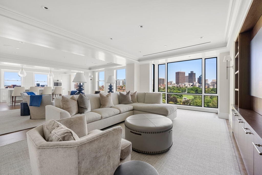 2 Commonwealth Avenue, Unit 11BCD Boston, MA 02116 - Photo 5 of 39 a living room with furniture a flat screen tv and a large window