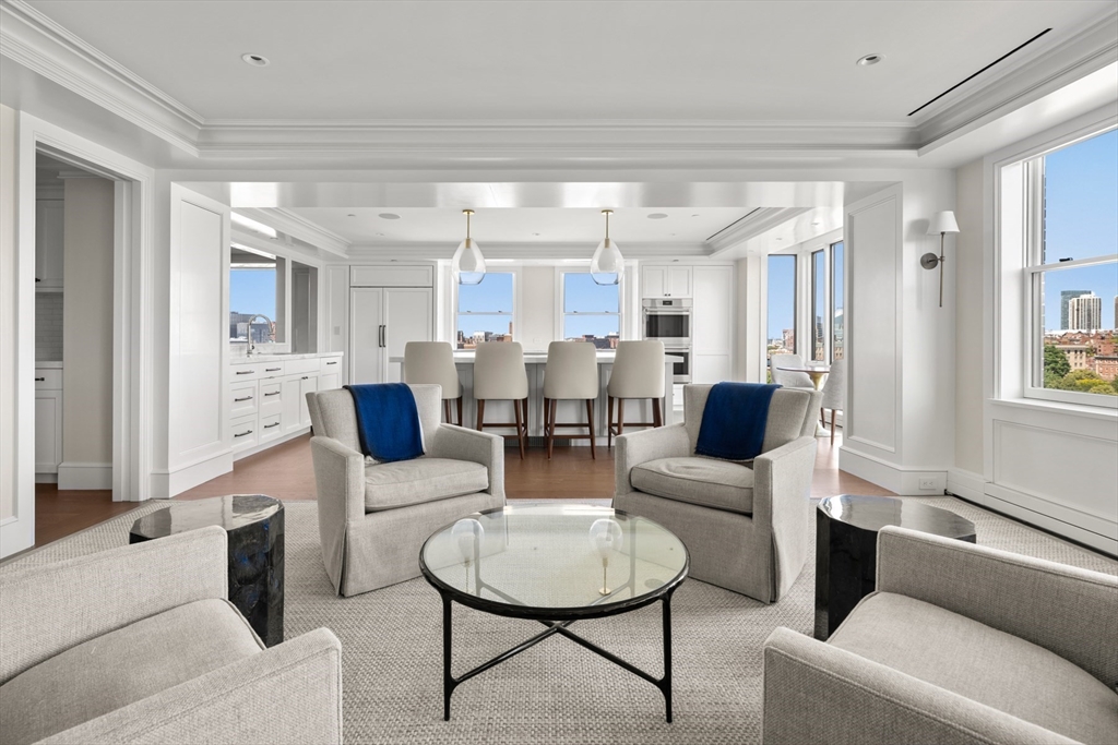 2 Commonwealth Avenue, Unit 11BCD Boston, MA 02116 - Photo 7 of 39 a living room with furniture and a chandelier