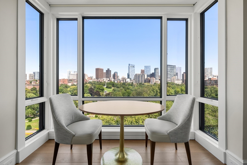 2 Commonwealth Avenue, Unit 11BCD Boston, MA 02116 - Photo 10 of 39 a view of a city from a dining room with furniture and a window