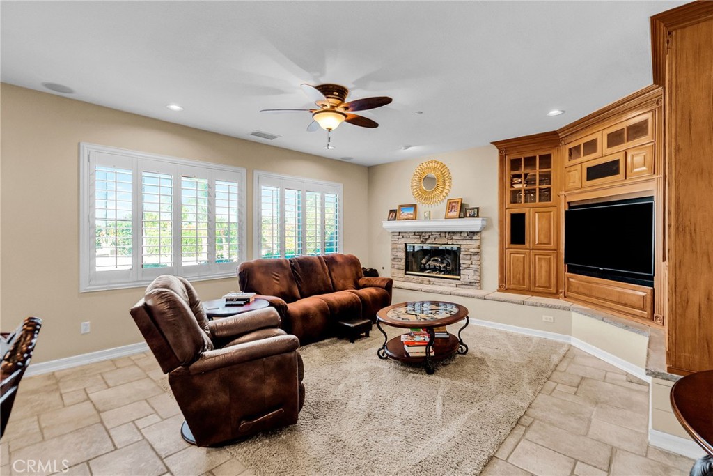 2542 Adage Way Riverside, CA 92506 - Photo 21 of 59 a living room with furniture a fireplace and a flat screen tv