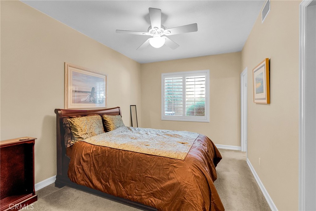 2542 Adage Way Riverside, CA 92506 - Photo 23 of 59 a bedroom with a bed and a window