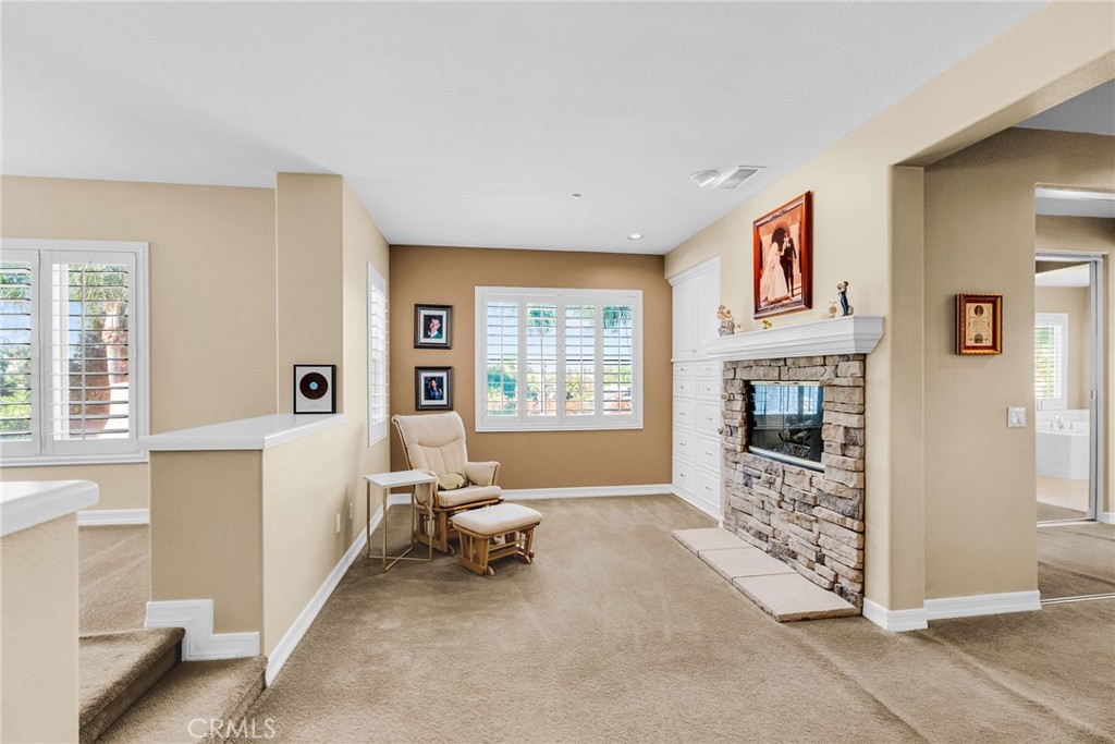2542 Adage Way Riverside, CA 92506 - Photo 28 of 59 a spacious bedroom with furniture and a fireplace