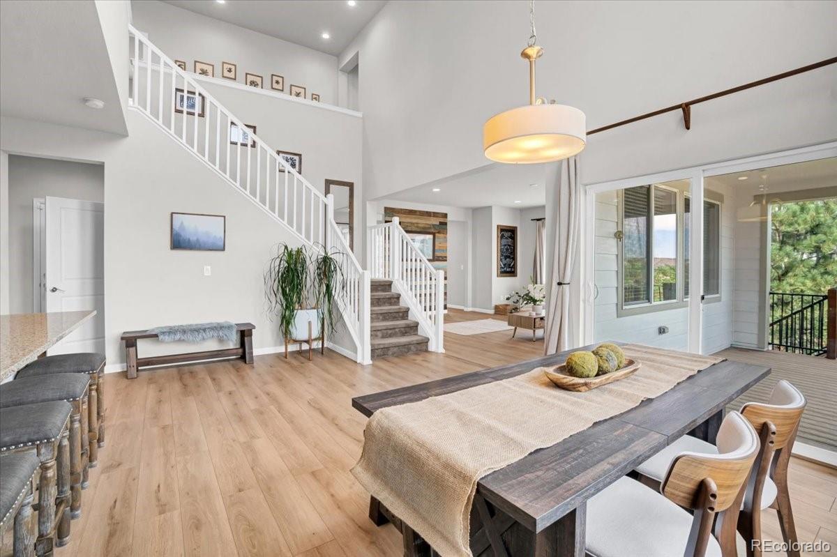 1767 Ghost Dance Circle Castle Rock, CO 80108 - Photo 1 of 48 a view of a dining room with furniture and wooden floor