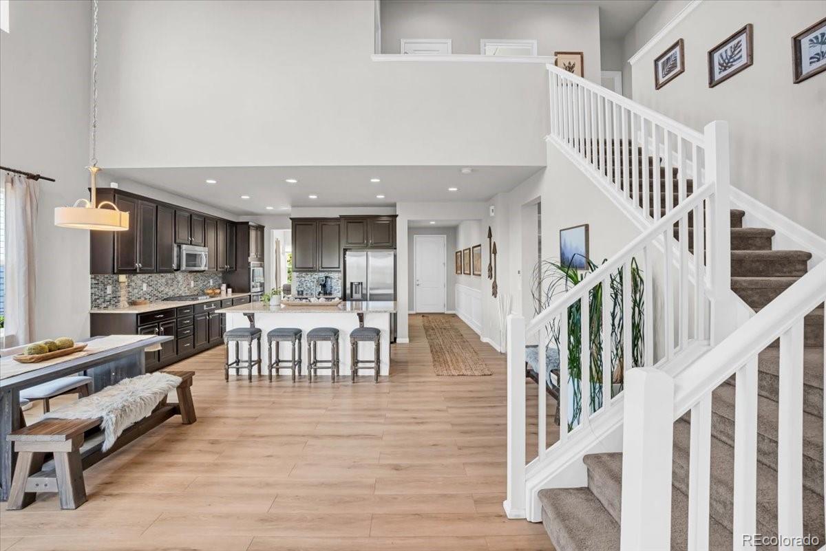 1767 Ghost Dance Circle Castle Rock, CO 80108 - Photo 13 of 48 a living room with lots of furniture and a wooden floor