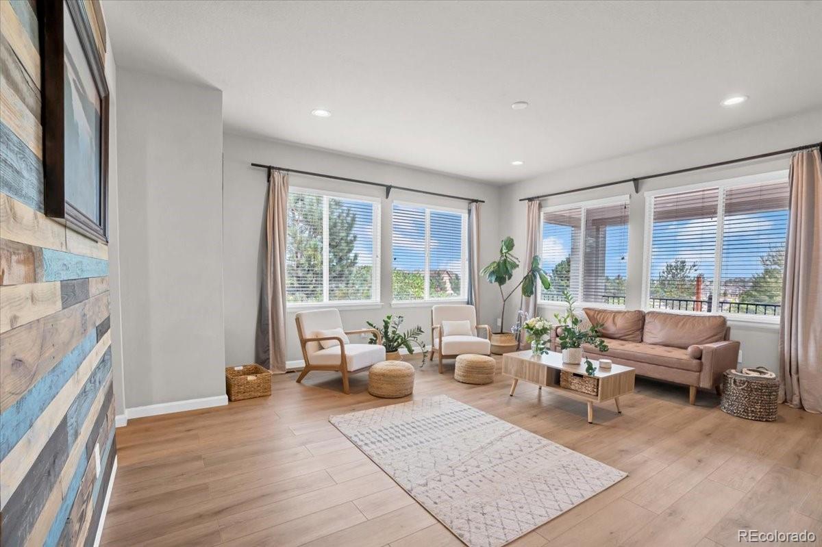 1767 Ghost Dance Circle Castle Rock, CO 80108 - Photo 15 of 48 a living room with furniture and large windows