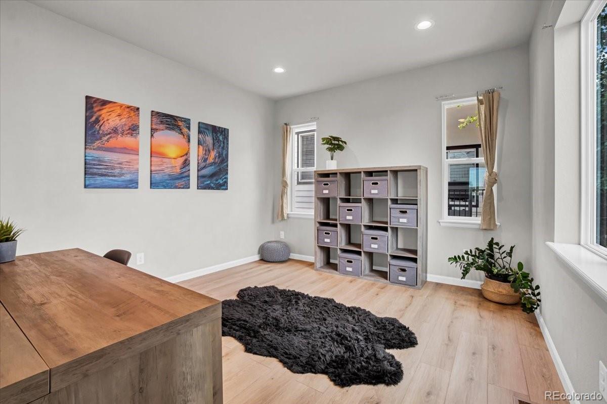 1767 Ghost Dance Circle Castle Rock, CO 80108 - Photo 16 of 48 a bedroom with a bed and a bookshelf
