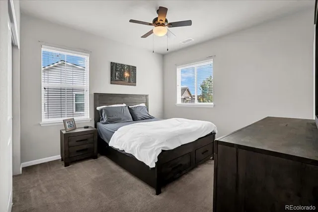 a view of a big room with wooden floor and windows