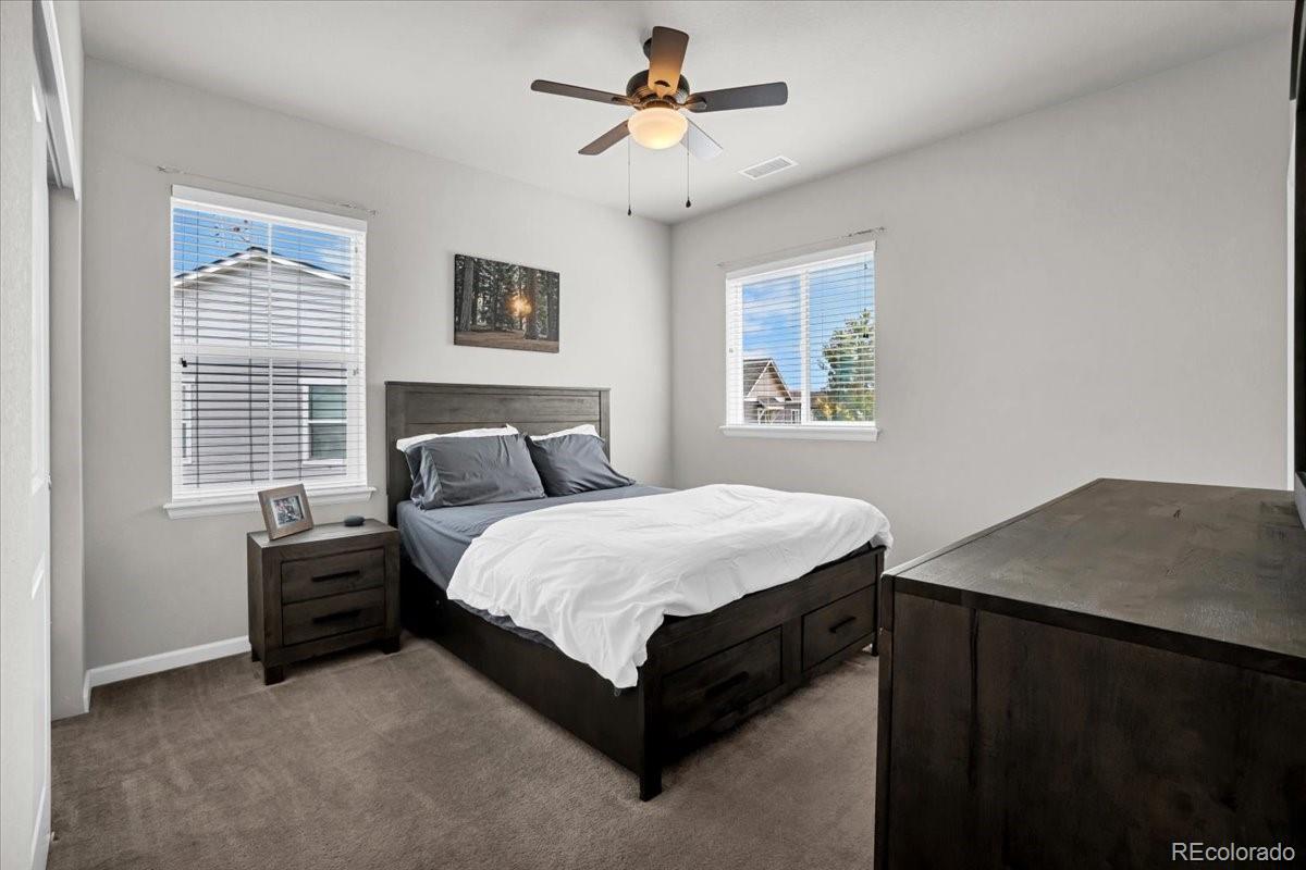 1767 Ghost Dance Circle Castle Rock, CO 80108 - Photo 21 of 48 a bedroom with a bed and a table