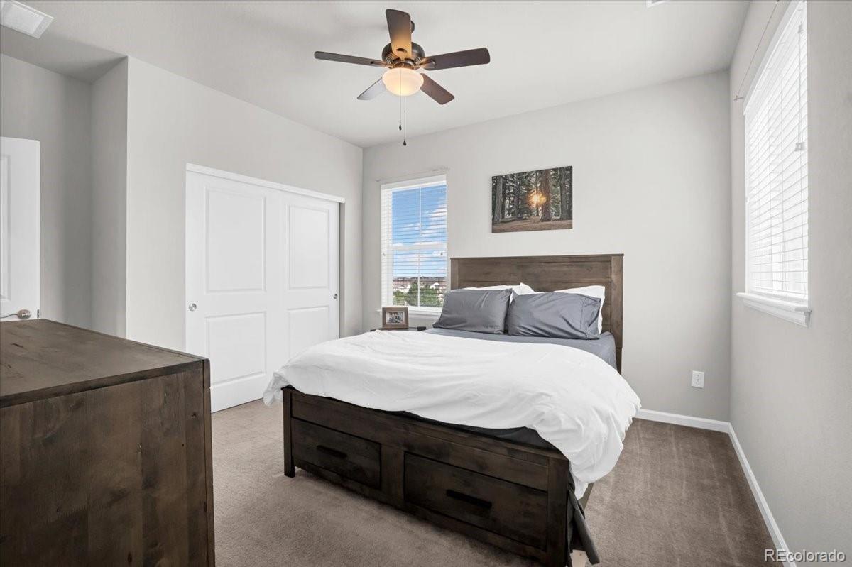1767 Ghost Dance Circle Castle Rock, CO 80108 - Photo 22 of 48 a bedroom with a bed and a table