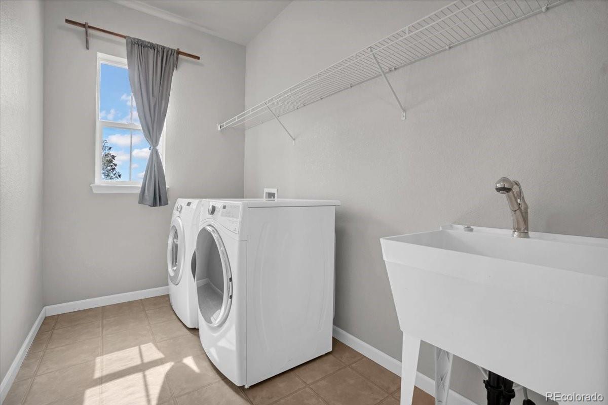 1767 Ghost Dance Circle Castle Rock, CO 80108 - Photo 24 of 48 a utility room with dryer and washer
