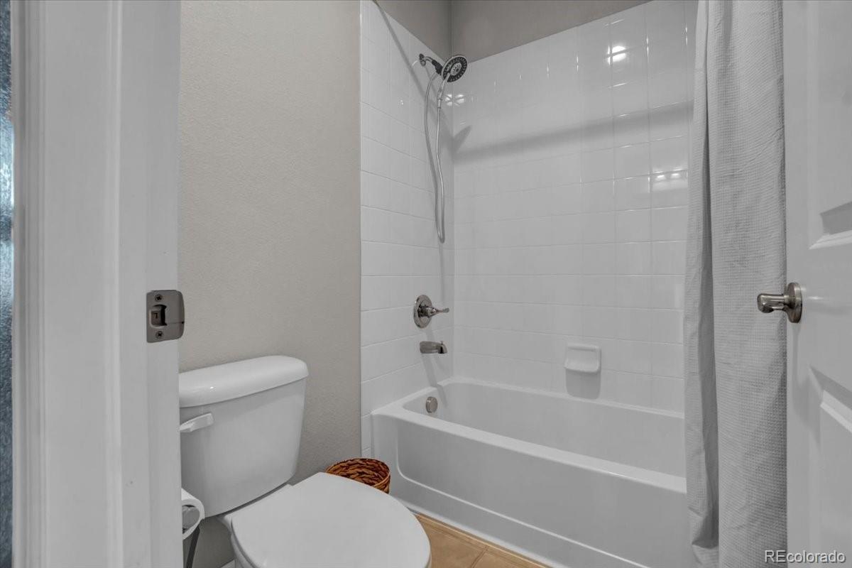 1767 Ghost Dance Circle Castle Rock, CO 80108 - Photo 28 of 48 a bathroom with a toilet and a bath tub