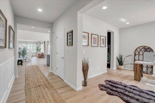 a living room with lots of furniture and a wooden floor